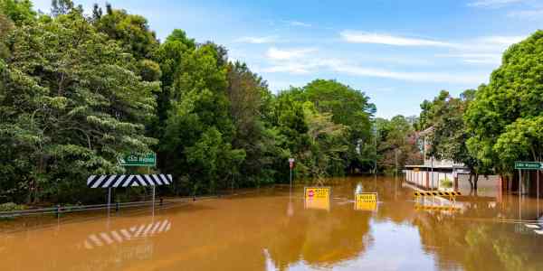 Flood sign on a road under water near the Lismore, NSW CBD.