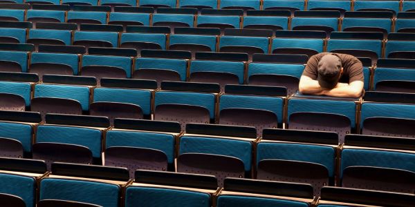 An image showing a sad person at university to illustrate an article on mental health and depression at university.