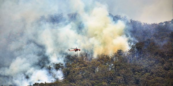 A photo of a helicopter fighting a bushfire in Australia, probably not using AI